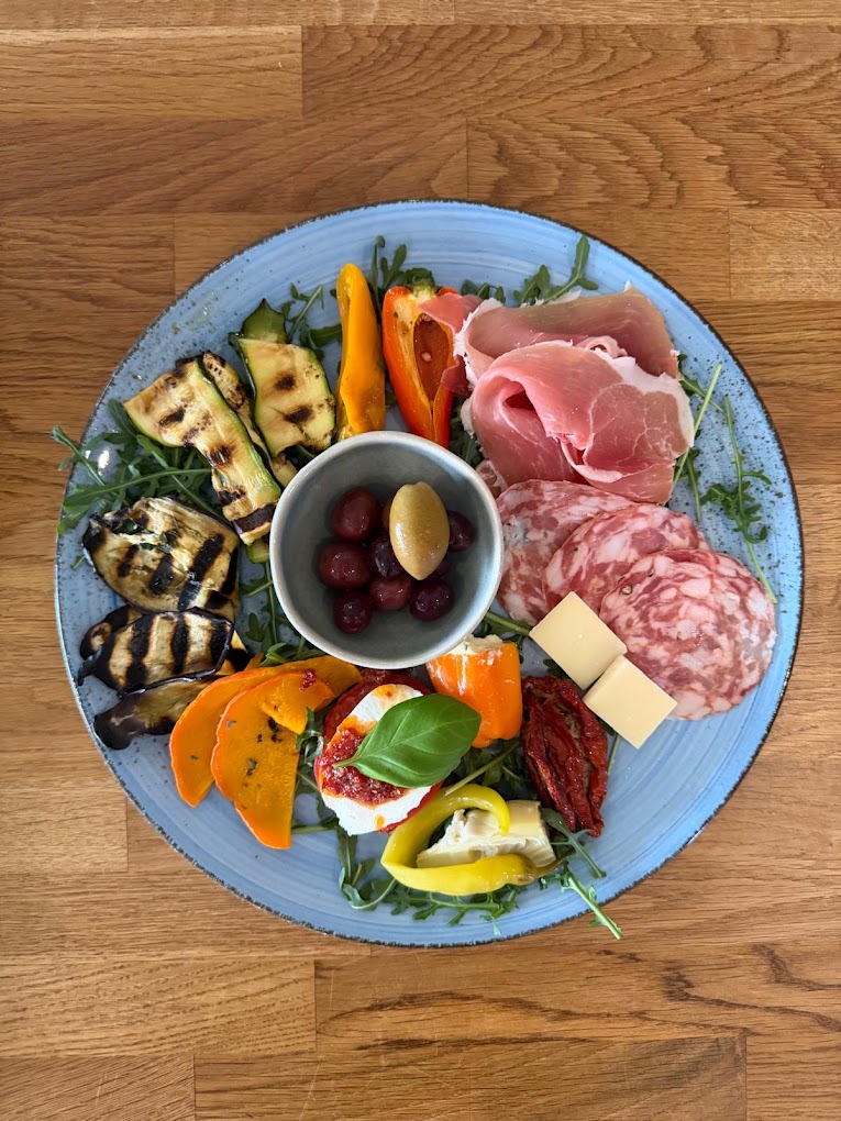 Antipastiteller mit gegrilltem Gemüse und Prosciutto